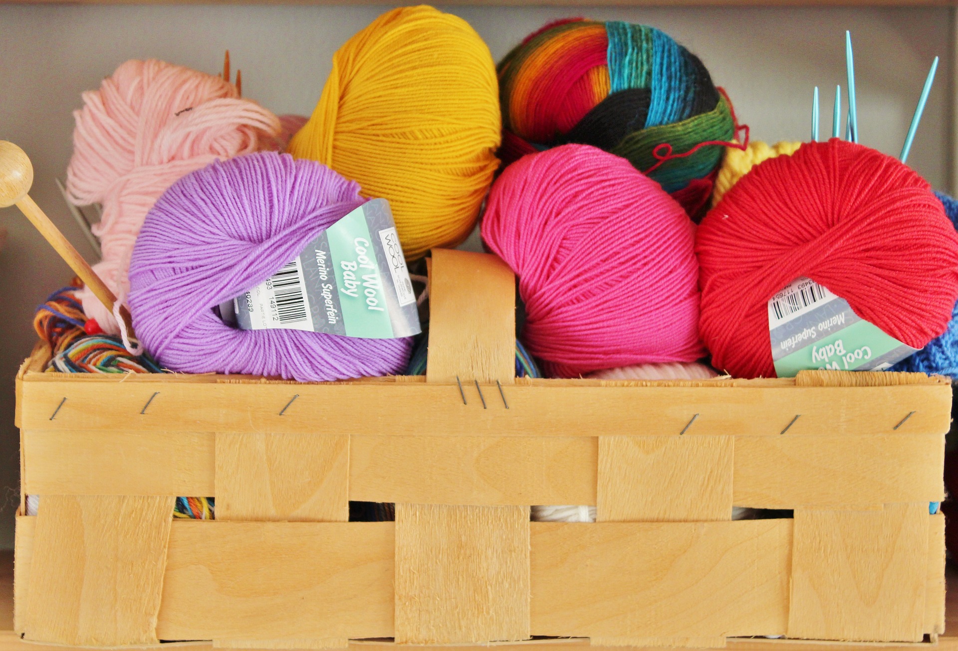 Colorful skeins of yarn in a basket.