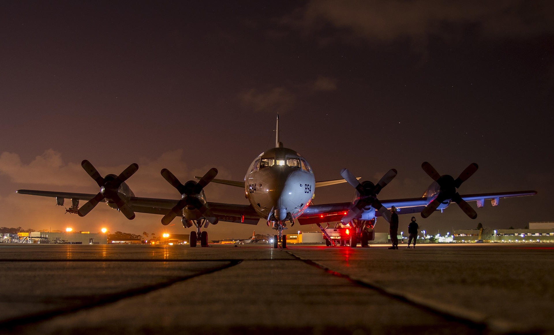 Plane on a runway at night.
