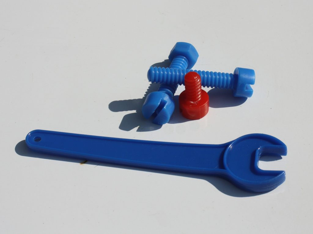 Plastic wrench and screws.