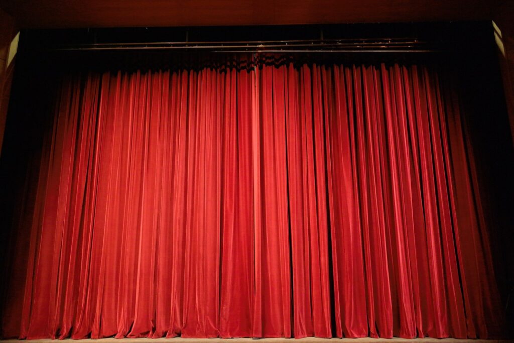 Red velvet curtains on a stage.